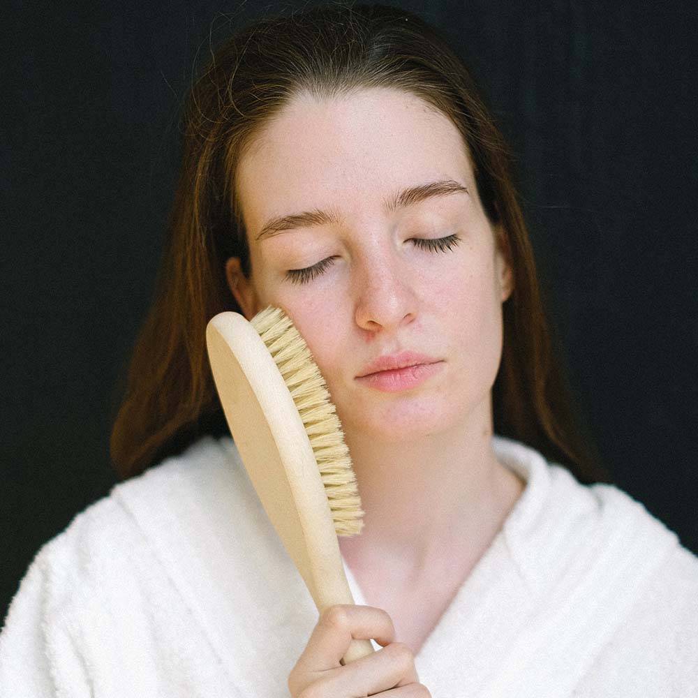 Girl brushing her face